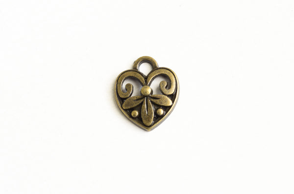 antique brass heart charm with a filigree design