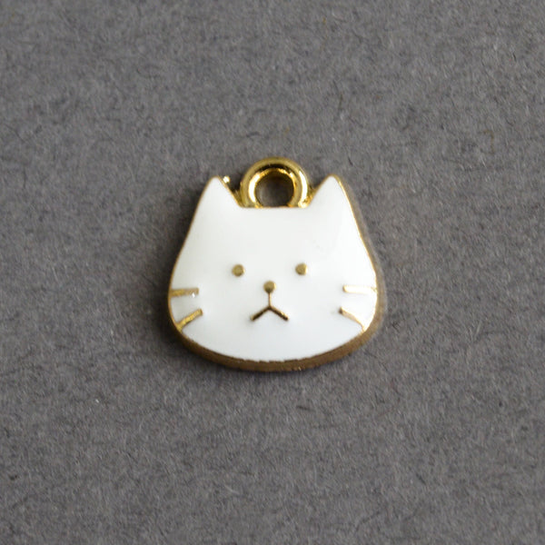 white enamel cat face charms with gold outline and face