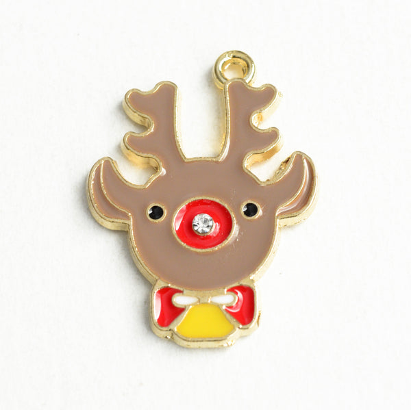 reindeer head charm made from beige enamel with red, yellow and white bow and nose. There are two tiny black eyes and a small crystal rhinestone in the center of the nose