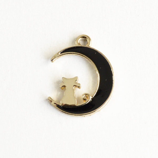 black crescent moon charms with a gold outline around the moon and a gold cat sitting inside the moon